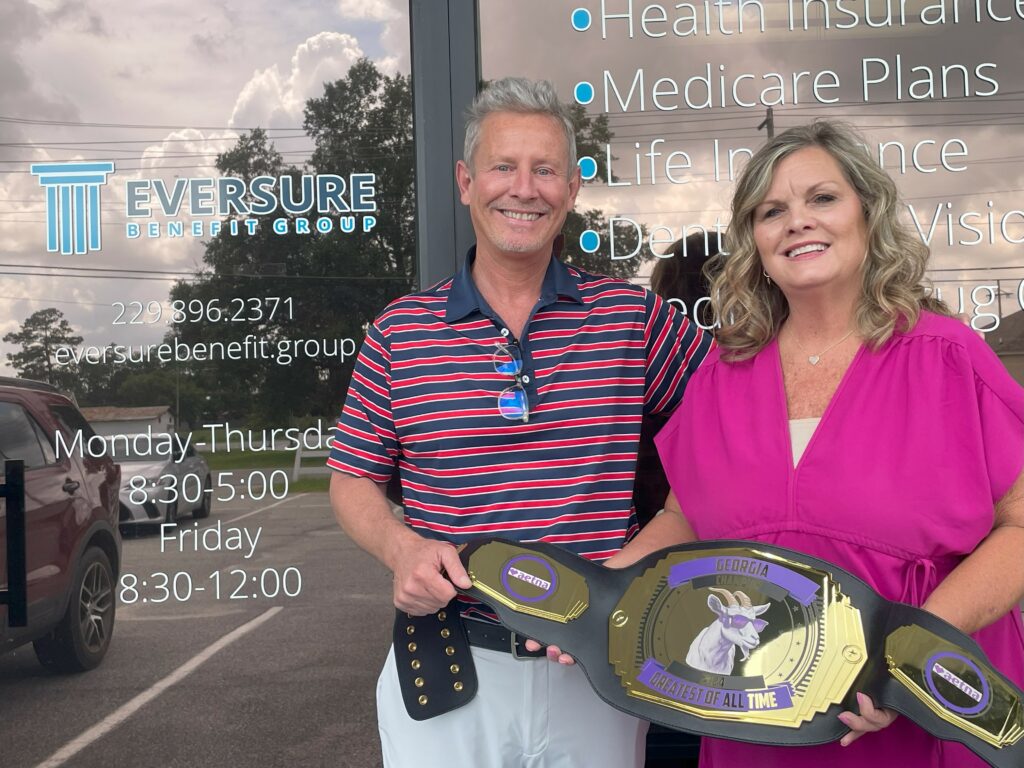 Agent Cathy Green and Aetna Regional Manager David Roberts holding Aetna's Top Georgia Producer award